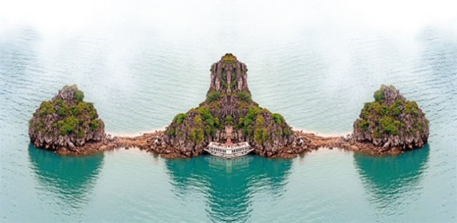 Vietnam Halong Bay cruise boat near tropical island. Aerial phot
