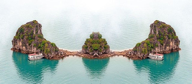 Vietnam Halong Bay cruise boat near tropical island. Aerial phot